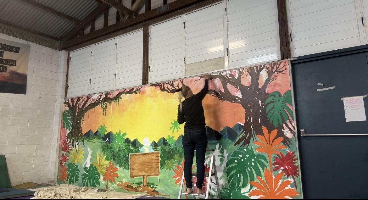 Tink Fletcher beside a completed mural