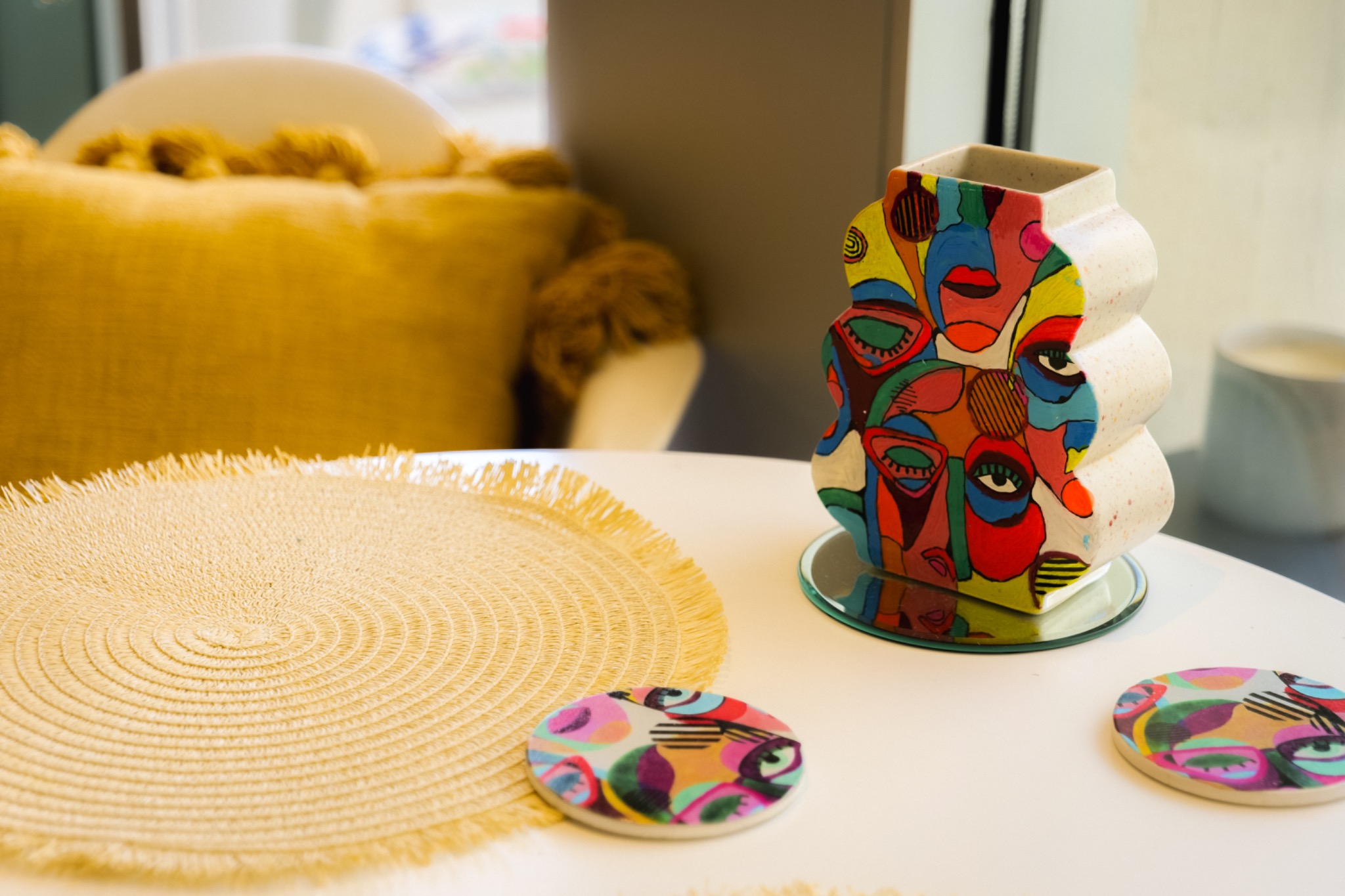 Colourful hand-painted ceramic vase and matching decorative pieces